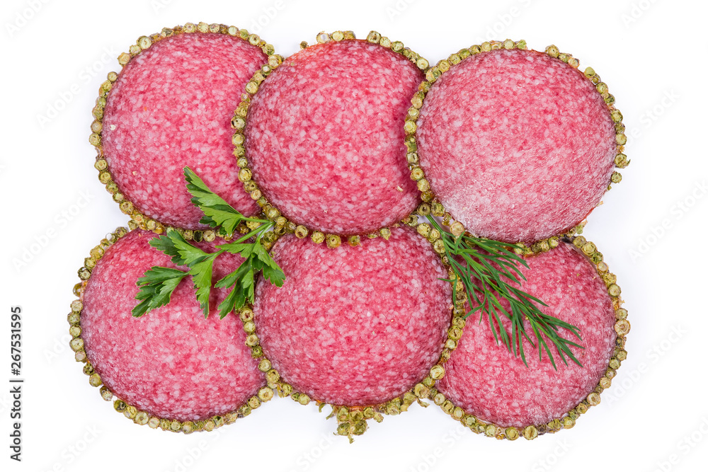 Slices salami with peppercorns crust with greens on white background Slices salami with peppercorns crust with greens on white background