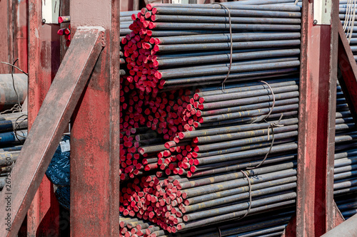 Metal rolling. A round tube are stacked in storage for sale and loading in stock in the open air.