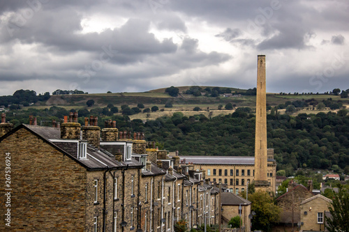 Victorian Salts Mill dominates the Aire Valley with the rolling landscape of Hope Hill, Baildon in the distance providing a contrast between nature and industry photo