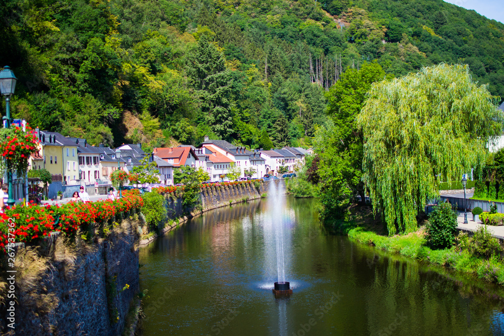 Our river crossing the old town of Vianden, Luxembourg, with typical houses, trees and the mountain at the background