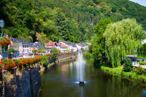 Our river crossing the old town of Vianden, Luxembourg, with typical houses, trees and the mountain at the background