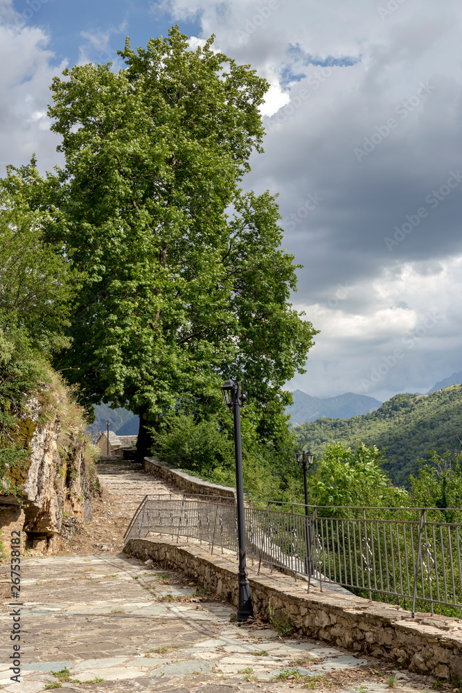Paved, narrow path in the mountains Paved, narrow path in the mountains