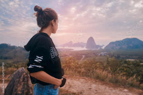 Rear view of a young woman enjoying the awesome view of Ao Phang Nga National Park photo