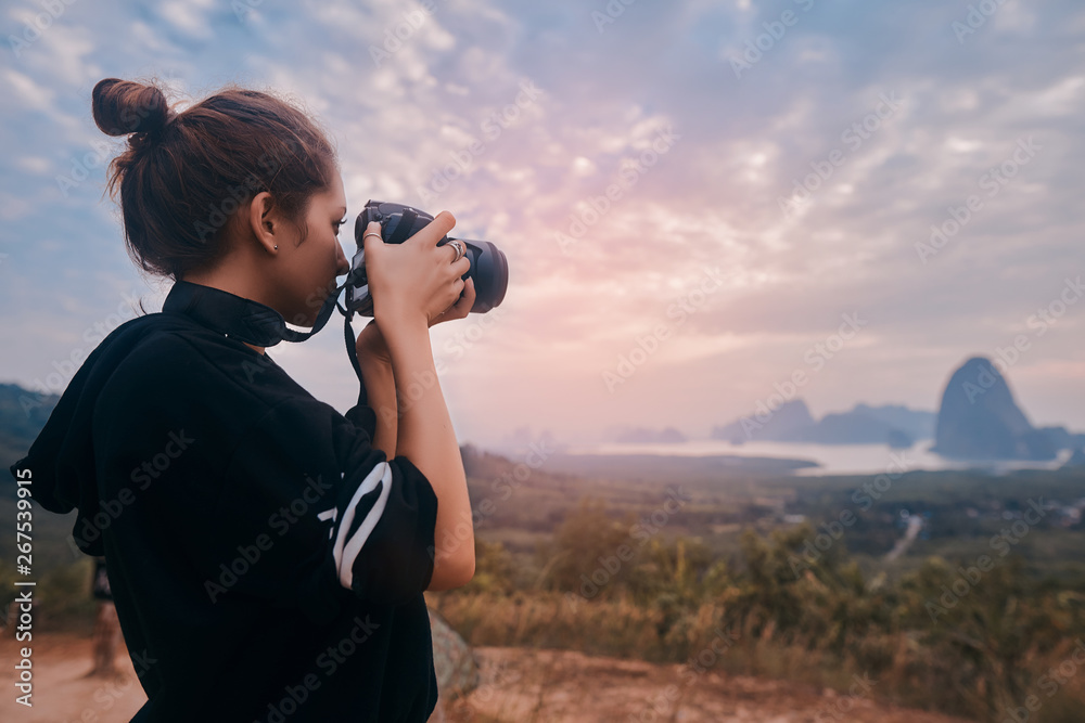 Rear view of a young woman photographer shooting the awesome view of Ao Phang Nga National Park
