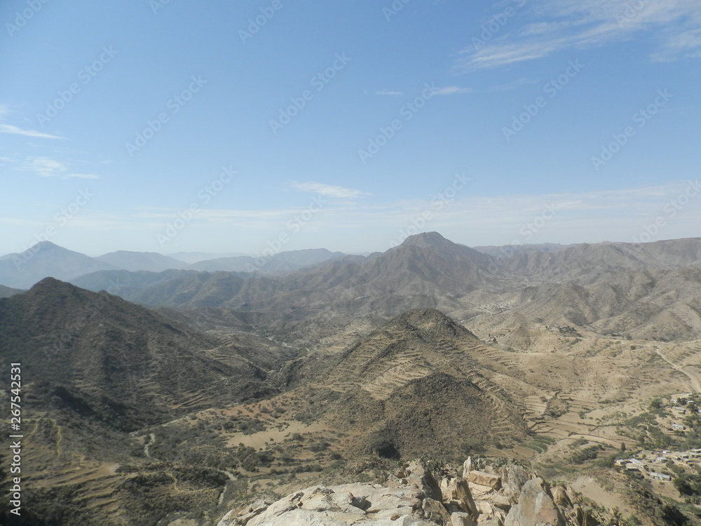 Segheneiti, Eritrea - 04/15/2019: Travelling around the vilages near Asmara and Massawa. An amazing caption of the trees, mountains and some old typical houses with very hot climate in Eritrea.