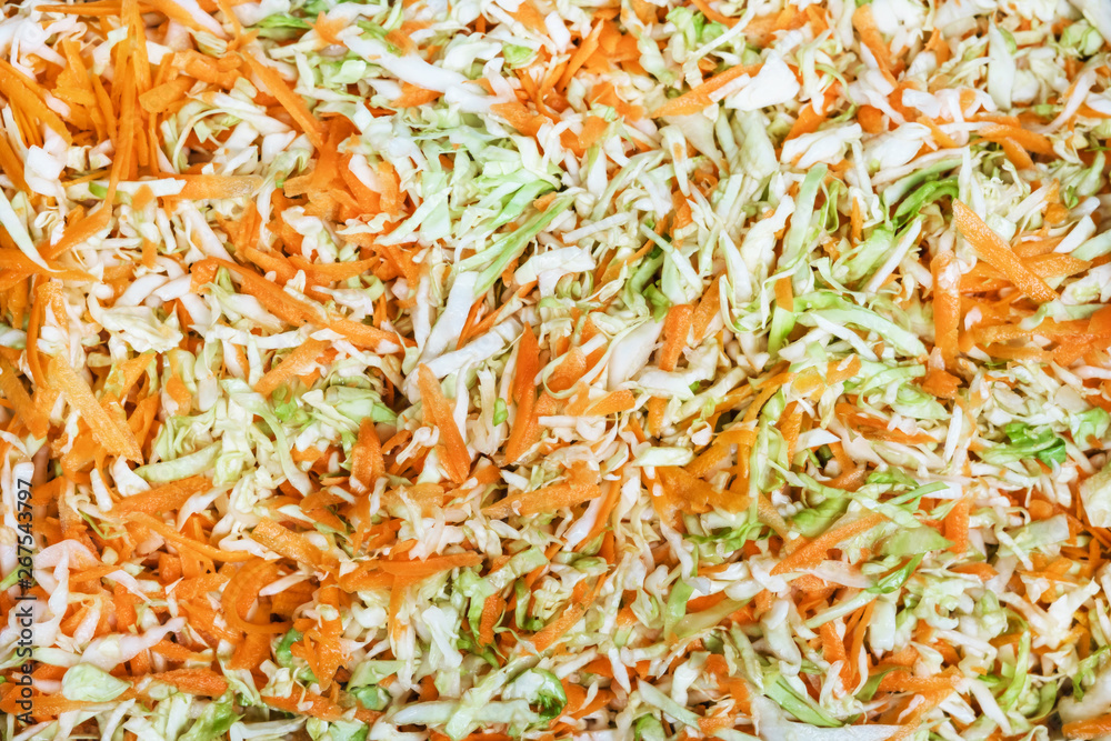 Fototapeta premium Sauerkraut and carrots in a wooden plate.