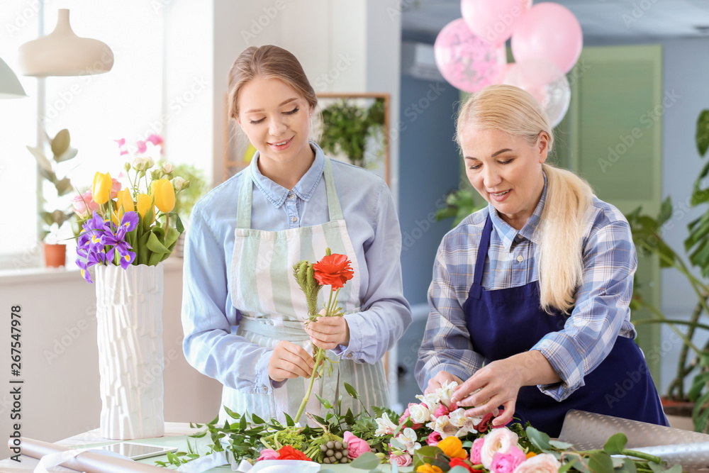 Florists making beautiful bouquet in shop Florists making beautiful bouquet in shop