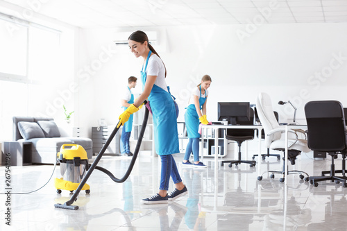 Team of janitors cleaning office photo