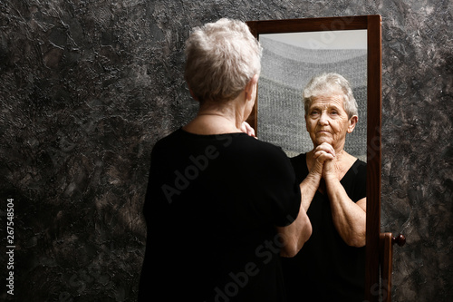 Senior woman looking in mirror