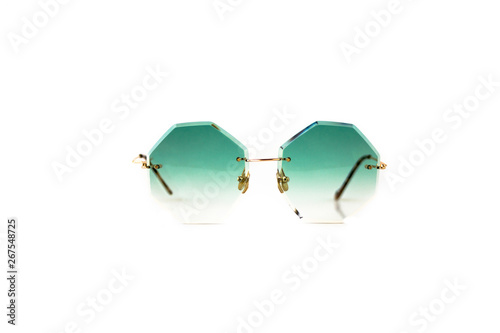 Green octagonal shaped gradient sunglasses with gold metal frame isolated on white background, front view.