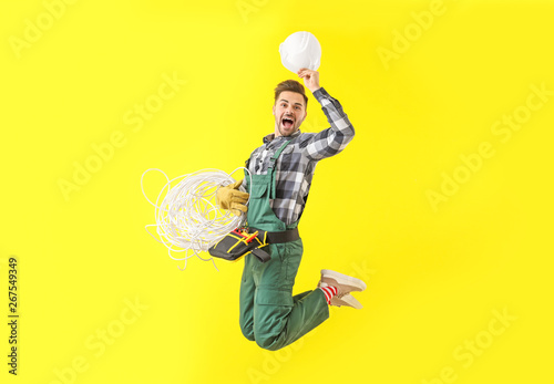 Jumping male electrician on...