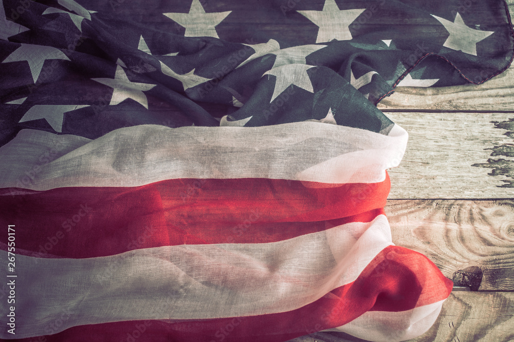 Fototapeta premium Patriotic symbols. American flag on an old wooden background.