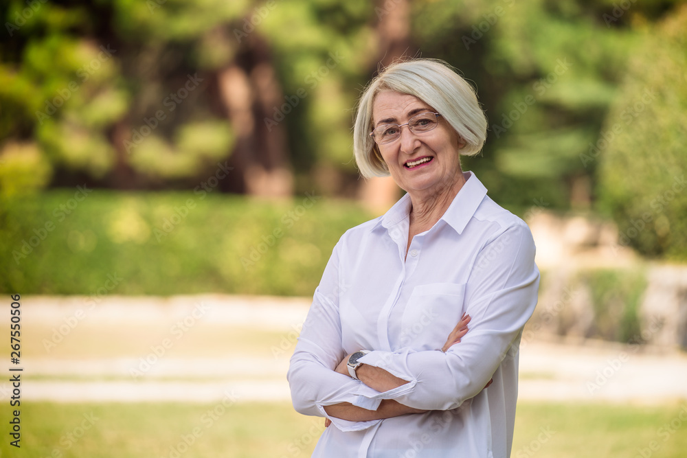 Portrait mature woman while resting at the park Portrait mature woman while resting at the park