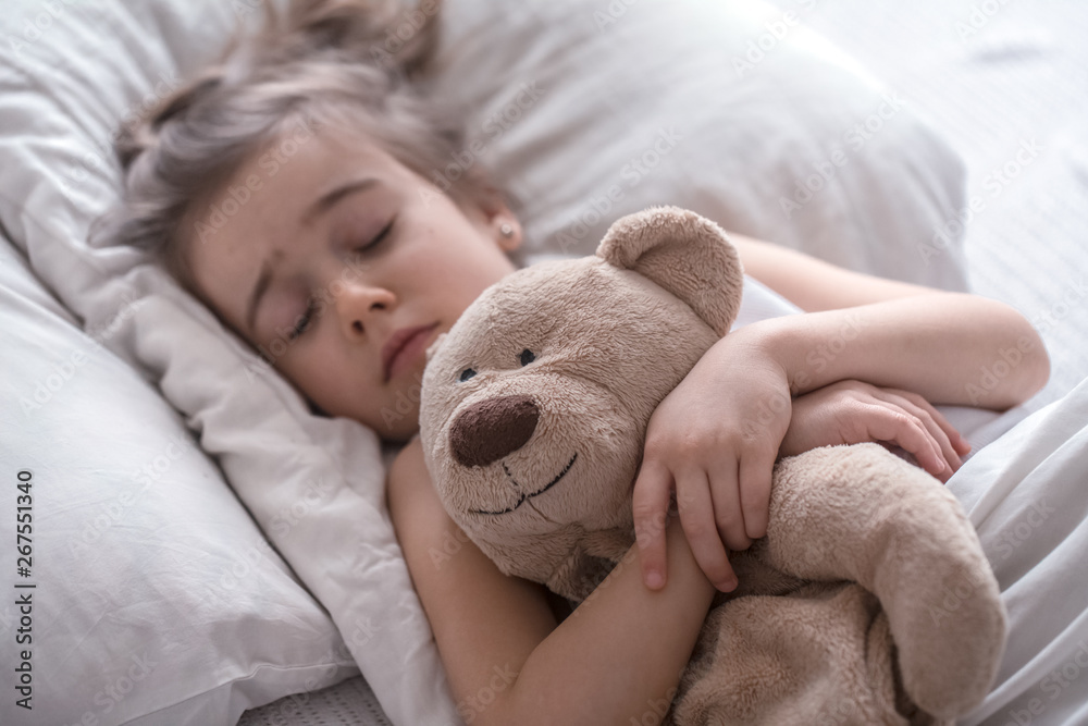 Little cute girl in bed with toy Little cute girl in bed with toy