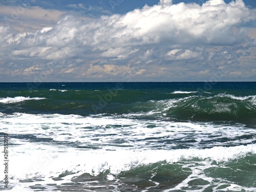 The peninsula of Crimea and Black sea. Emerald and pearl color of Black sea waves. The wild coast on the raging Black sea in the area of Chersonesos cape