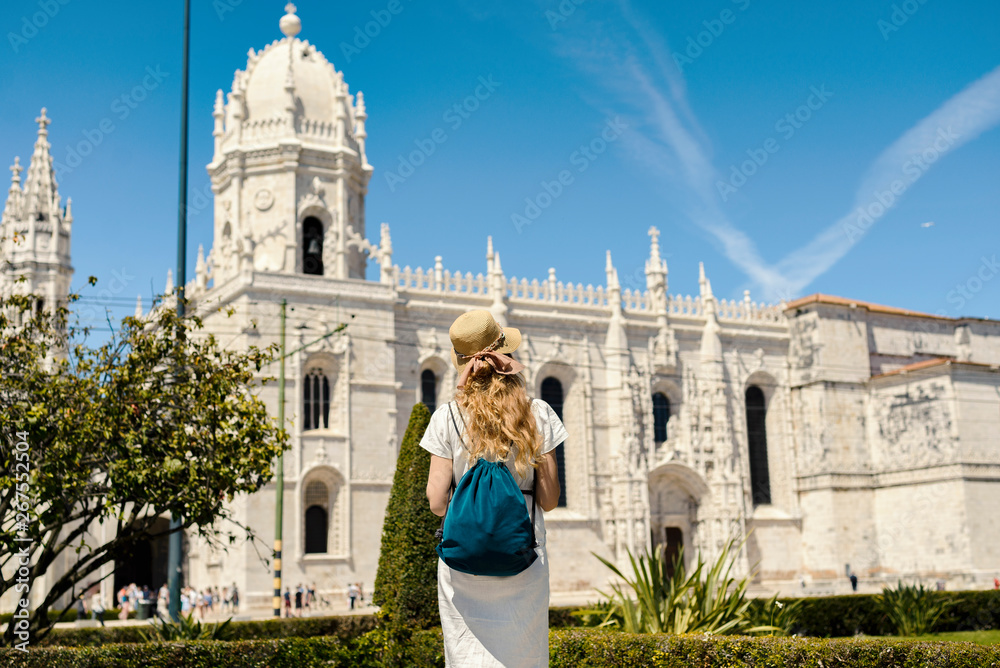Young tourist exploring Belem and its Hieronymites Monastery architecture from XVI century, which is on UNESCO list