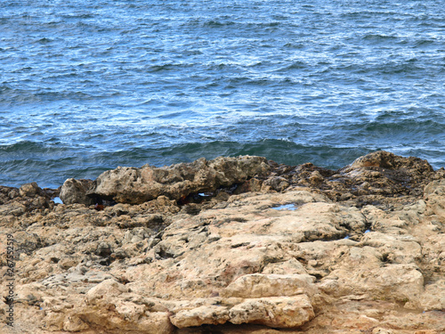 Picturesque view of stone wild Crimean coast of Black sea in the area of Chersonesos cape. The peninsula of Crimea