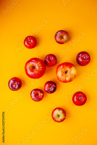 Red apples in row  circle isolated on yellow background and space for word