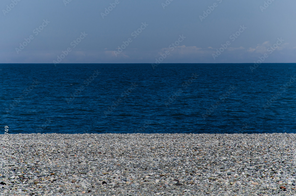 Batumi beach. small stones on the rocky shore. copy space