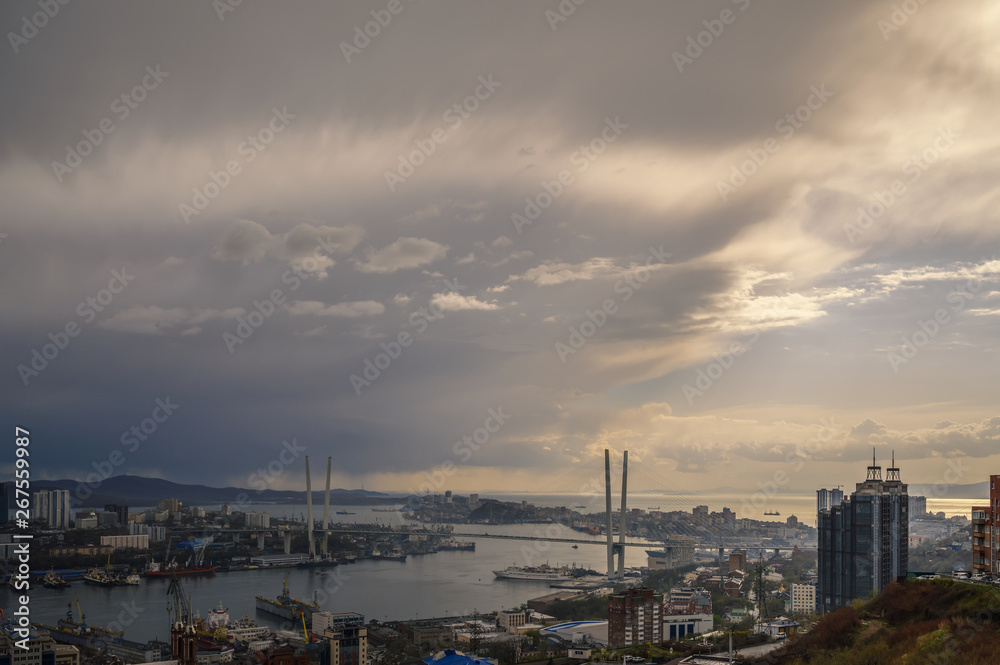 Vladivostok cityscape - storm over city. Toned image.