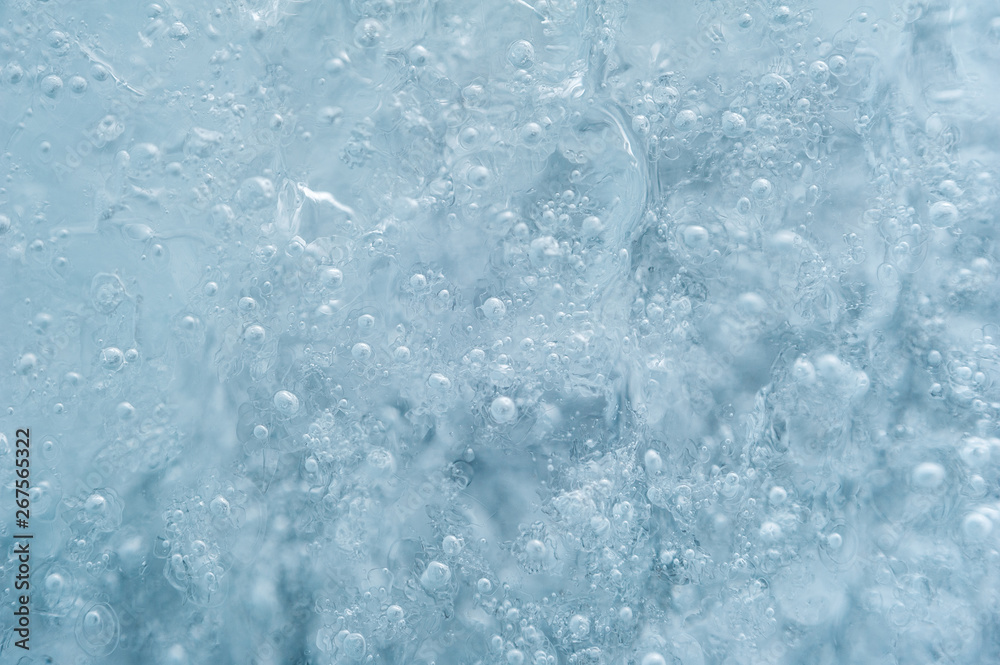 Ice with bubbles background texture. Refreshing summer drinks or arctic cold concept.