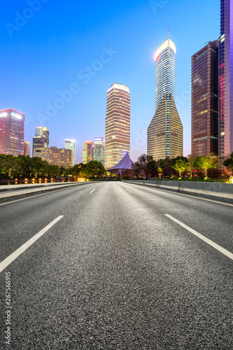 Shanghai modern commercial office buildings and empty asphalt highway at night © ABCDstock