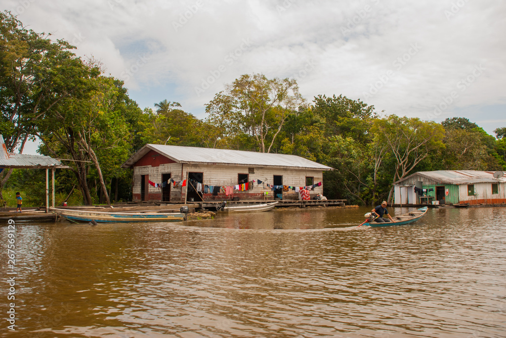Foto Stock Amazon river, Amazonas, Brazil: Wooden local huts, houses on the  Amazon river in Brazil. | Adobe Stock