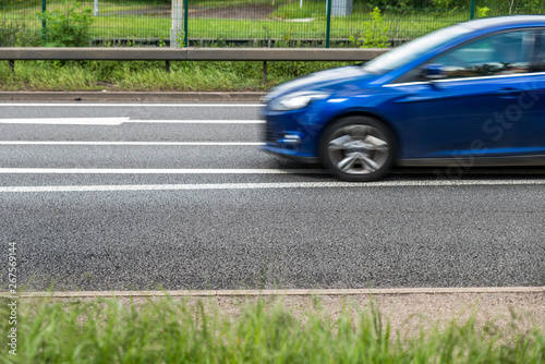 blue car on uk motorway in fast motion
