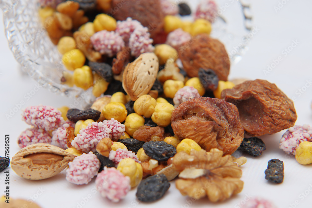 Sweet dried fruits and nuts in a crystal vase.