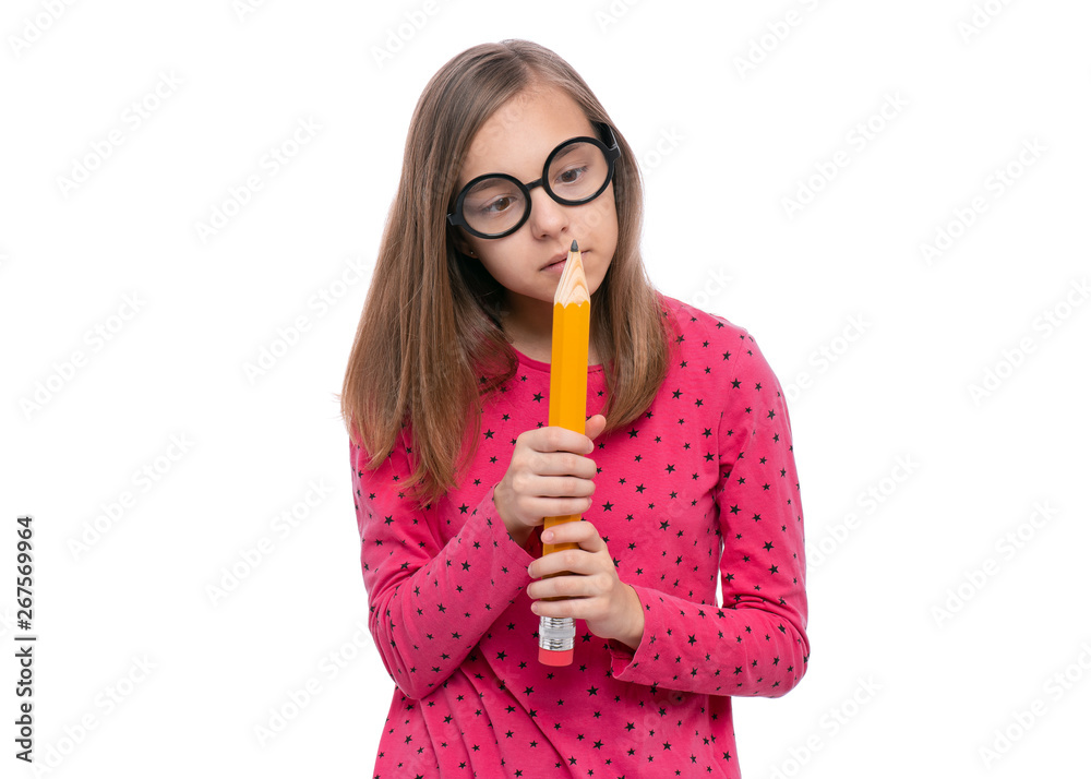 Portrait of beautiful Teen Girl in funny eye Glasses holding Big Pencil, isolated on white background. Crazy child making grimace - Silly face. Back to School and childhood concept. Portrait of beautiful Teen Girl in funny eye Glasses holding Big Pencil, isolated on white background. Crazy child making grimace - Silly face. Back to School and childhood concept.
