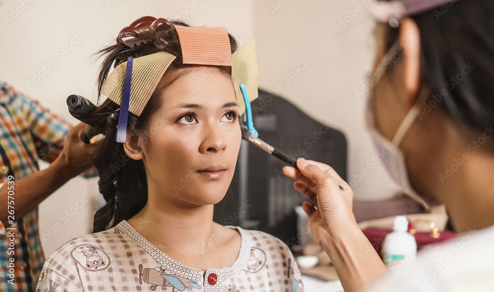 Beauty concept. makeup artist creates makeup for eyelids. Applying eyeshadow young woman,