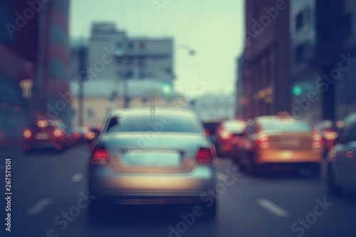 view of car in traffic jam / rear view of the landscape from window in car, road with cars, lights and the legs of the cars night view