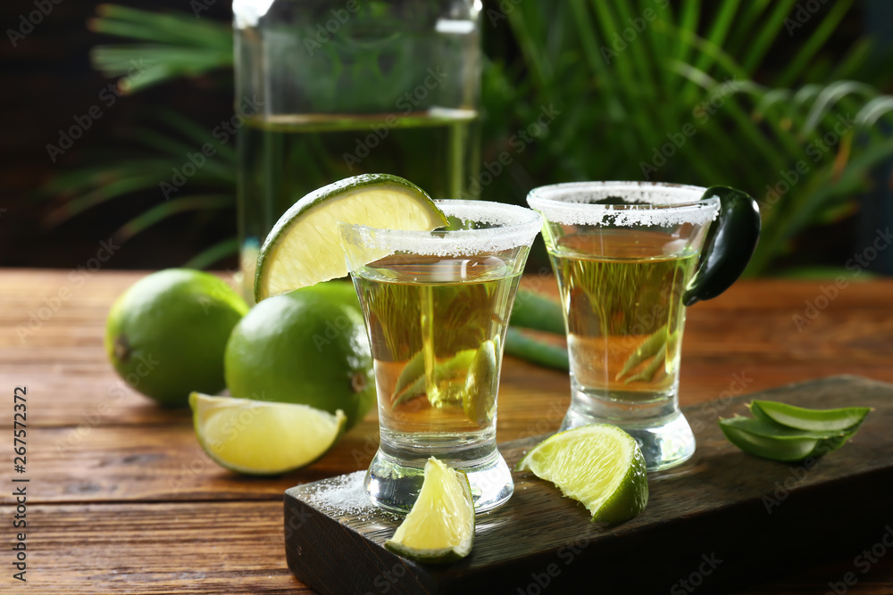 Shots of tequila on wooden table Shots of tequila on wooden table