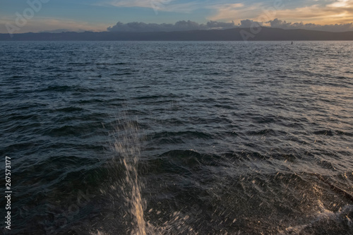 Landscape of Ohrid Lake at sunset. With waves breaking into the shore. Northern Macedonia.