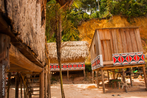 Large house covered with sape grass, Indigenous tribe village near Manaus, Amazonas State, Brazil photo