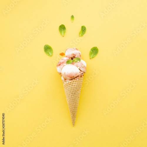 Ice cream in waffle cone with syrup and mint