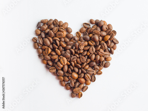 Coffee beans in heart shape on white background