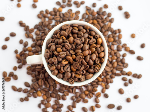 Coffee beans in white cup isolated on white background, drinks concept. top view