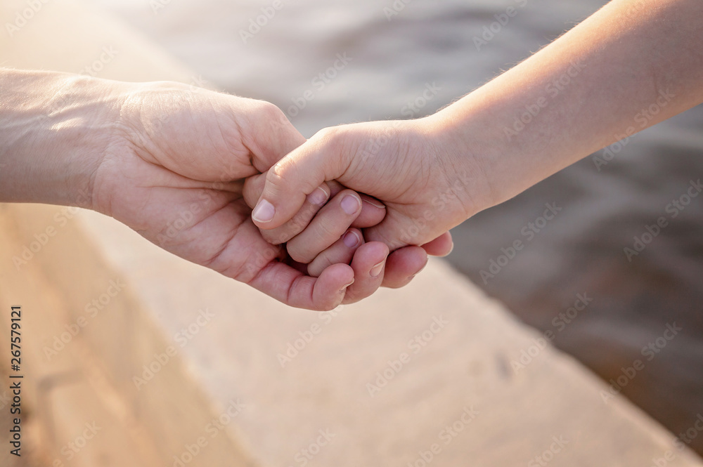 Mom holds her daughter's hand. Happy family concept