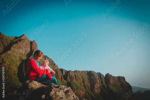 mother and little daughter enjoy travel in mountains