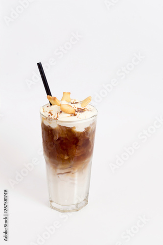 Glass of cold coffee drink with whipped cream, syrup and cookies on white background. Beverages, menu concept. Close-up, copy space, layout design, vertical format