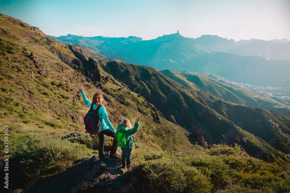 Fototapeta premium happy mother with little daughter travel in mountains