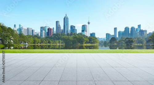 Empty floor with park and modern cityscape . Morning scene . photo