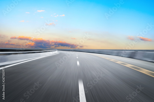 Motion-blurred highway in dusk clouds 