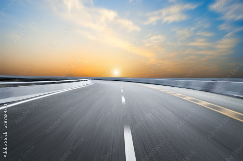 Naklejka premium Motion-blurred highway in dusk clouds