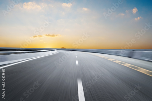 Motion-blurred highway in dusk clouds 