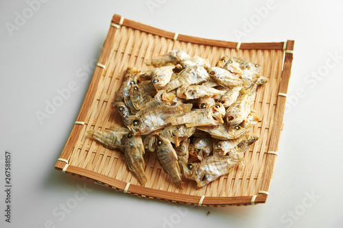 Dried fishes on bamboo sieve  photo