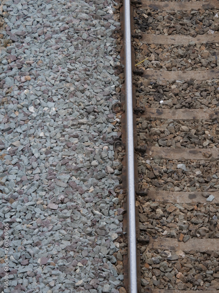 Top view of the train tracks with train and rock restraints in construction. Top view of the train tracks with train and rock restraints in construction.