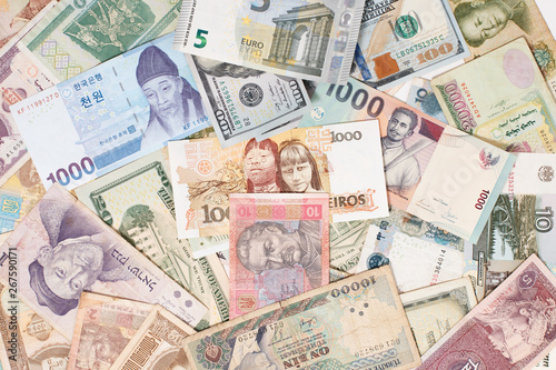 many different currencies as colorful background concept global money