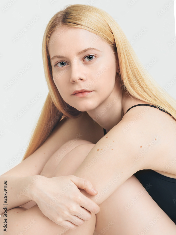 Skin care Close-up photo Beauty portrait of a young blonde woman with clean skin and moles in her arms Cropped image Skin care Close-up photo Beauty portrait of a young blonde woman with clean skin and moles in her arms Cropped image